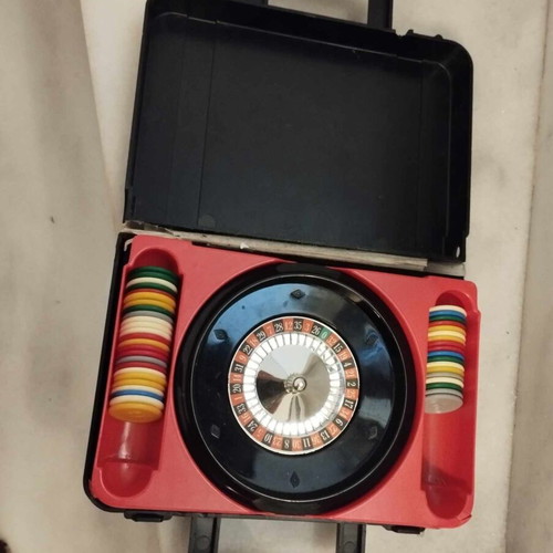 Vintage roulette pocket case with chips used