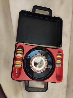 Vintage roulette pocket case with chips used