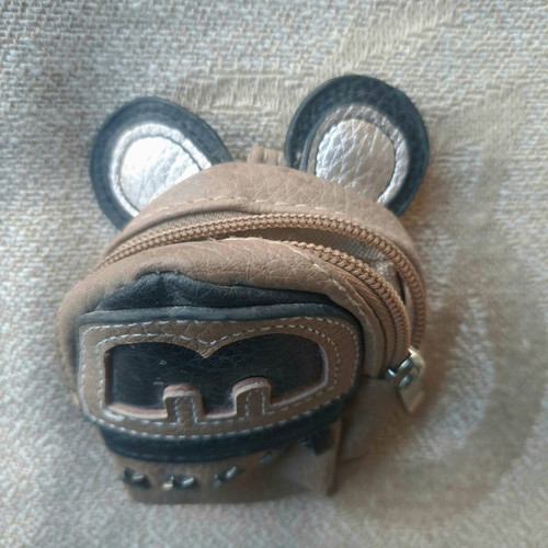 Coin purse used in mini backpack shape with decorative ears and letter M