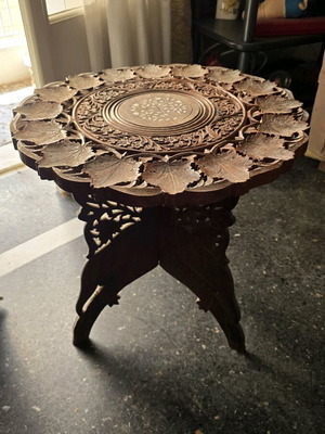 Carved coffee table used, 45cm height and 45cm diameter