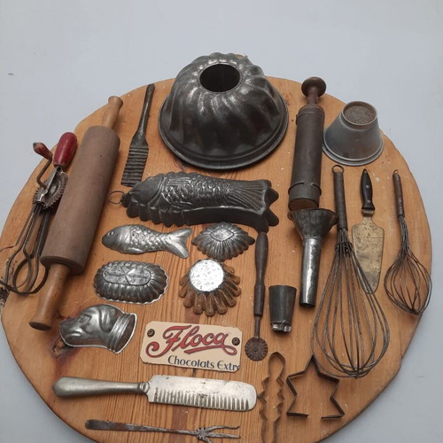 Collection of vintage pastry tools on wooden board