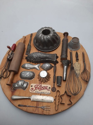 Collection of vintage pastry tools on wooden board