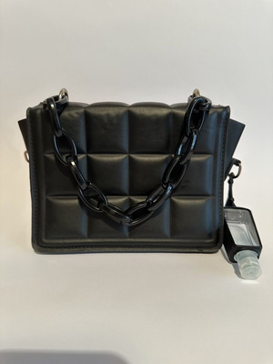 Leather handbag like new, black with shoulder strap and sanitizer bottle
