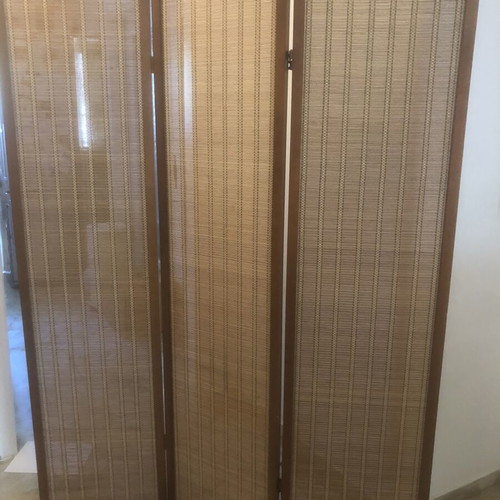 Brown bamboo room divider with slight wear