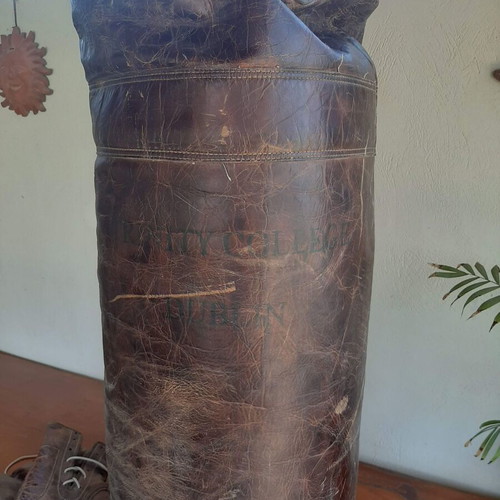Antique leather boxing bag and gloves with Dublin college stamp