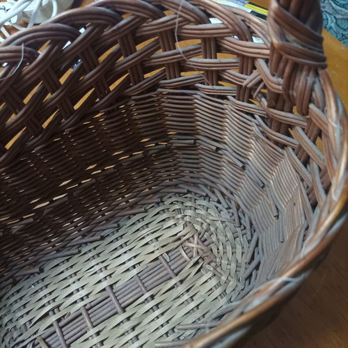 Handmade dark brown wicker basket with high arched handle