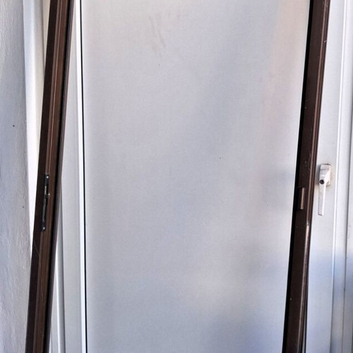 Two brown aluminum entrance doors with frames, handles and locks
