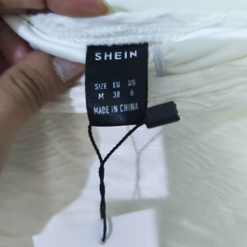 White all-in-one shorts with embossed designs Shein