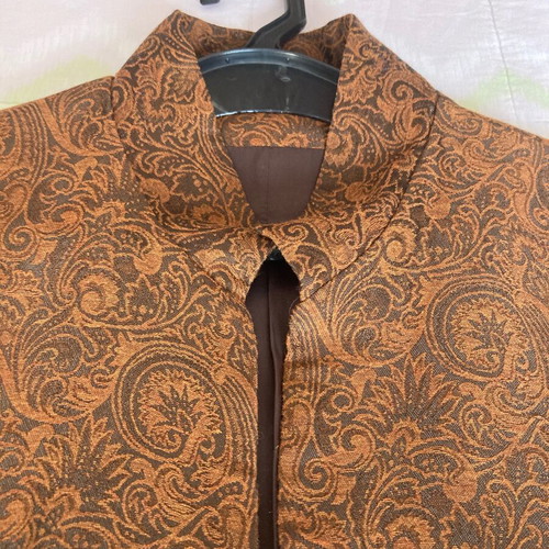Long women's jacket with embossed fabric and metal buttons brown