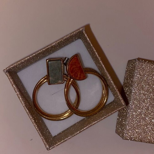 Gold hoop earrings used with detail on top part