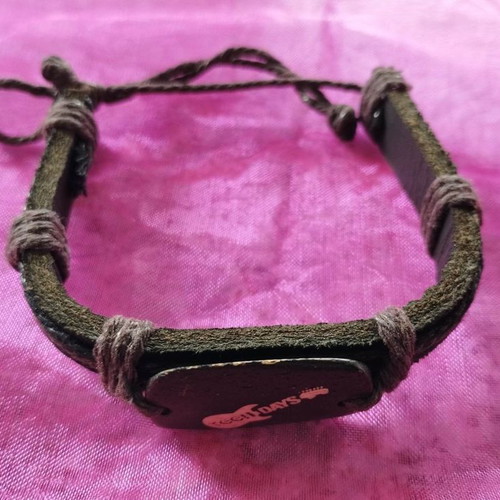 Brown bracelet new with wooden guitar decoration and cord details