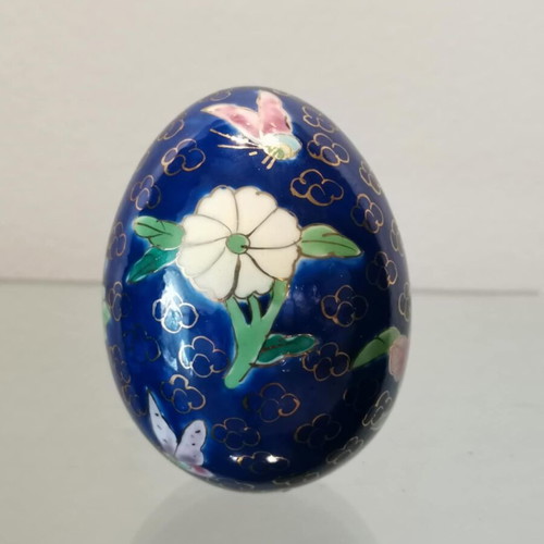 Porcelain egg used with hand-painted flowers and decorative butterflies