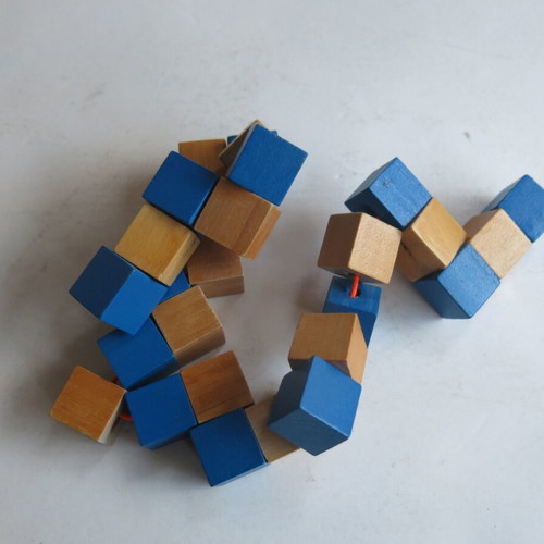 Wooden snake puzzle like new that transforms into a cube