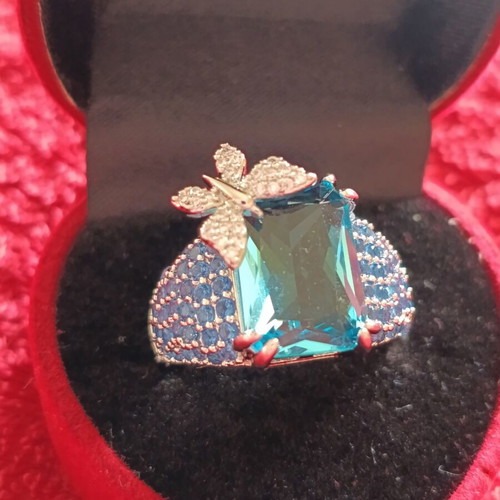 Women's ring new with emerald cut blue stone and butterfly detail