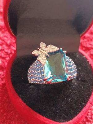 Women's ring new with emerald cut blue stone and butterfly detail