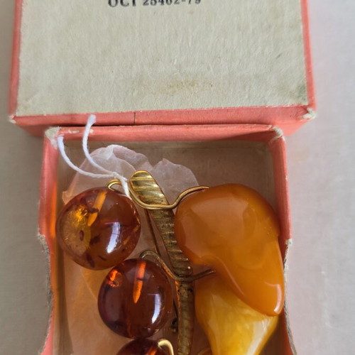 Baltic amber brooch with grape cluster design