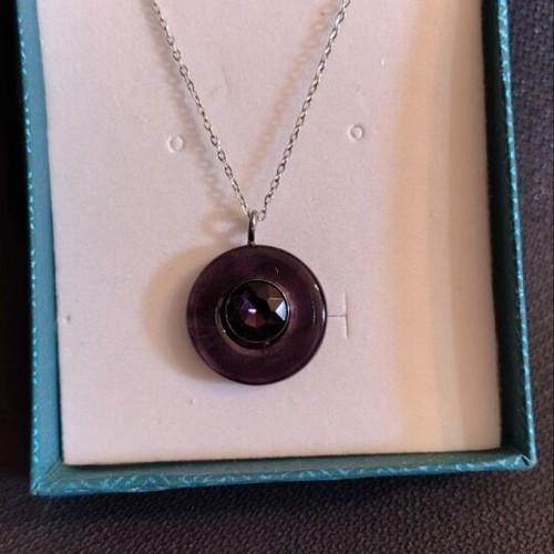 Necklace with hematite wheel-shaped pendant like new