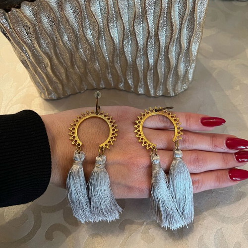 Dangling earrings used with grey tassels and gold details