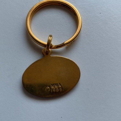 Vintage Metropolitan Museum of Art keychain with blue enamel and gold-plated peace bird pendant, like new