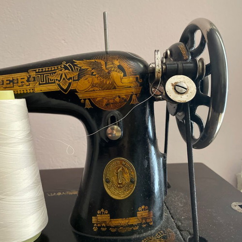 Singer 1960 foot-powered sewing machine used, wooden cover and table