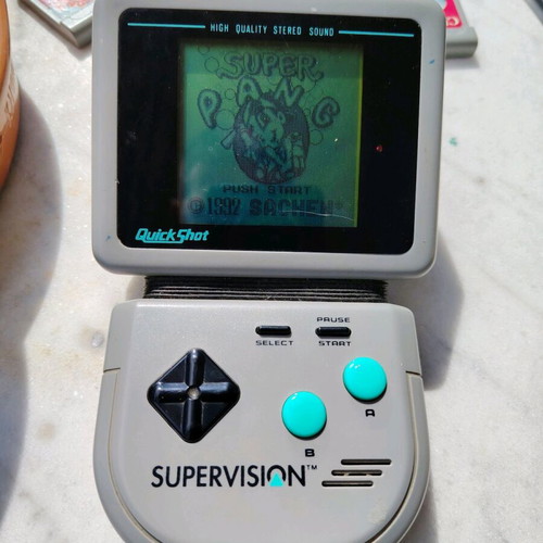 Watara Supervision console used with 3 games