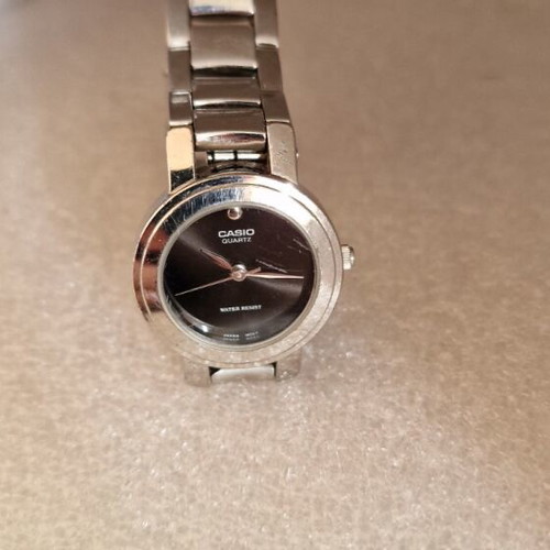 Casio women's watch used with black dial and metal bracelet