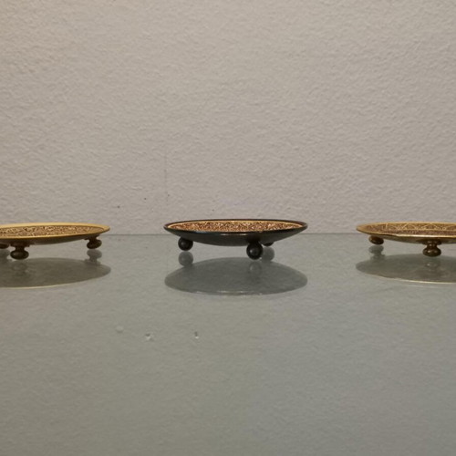 Set of three used metal candle holders with Arabic designs