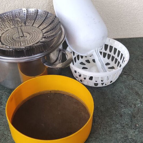 Cookware set used with pot, steamer, sieve, and colander