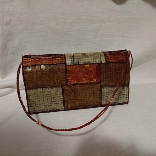 Official hand bag like new in brown shades with sequins
