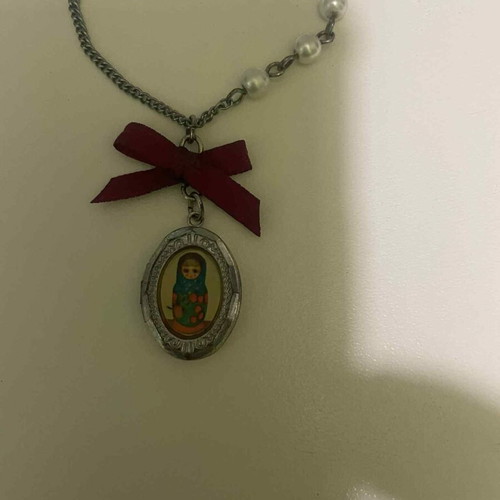 Pendant used with silver chain, pearls and retro bow