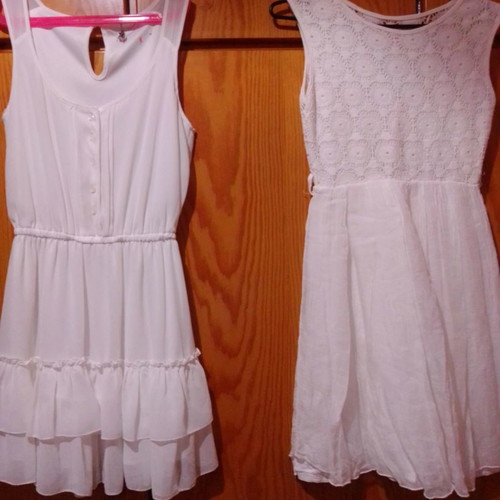 Two white dresses used, sizes 12-14 for girls