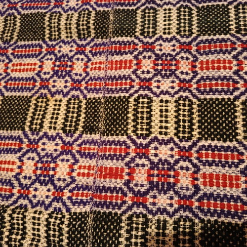 Vintage woolen blanket with red, purple, white and dark green patterns