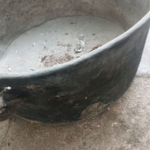 Large handmade bronze cauldron used with iron handles