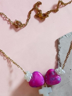 Handmade necklace with colorful hearts and white bone cross on gold steel chain