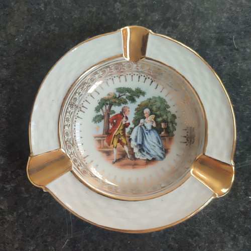Vintage porcelain ashtray used with romantic scene and gold details