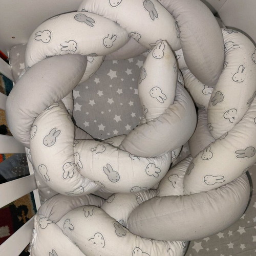 Baby braided crib bumper used in gray and white