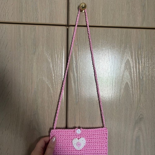 Children's pink knitted bag with heart and button