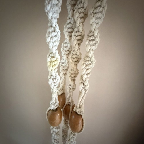 Macrame plant hanger used with wooden beads for pots