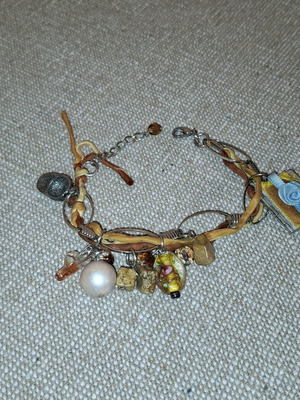 Fabric bracelet used like new, brown beige with charms
