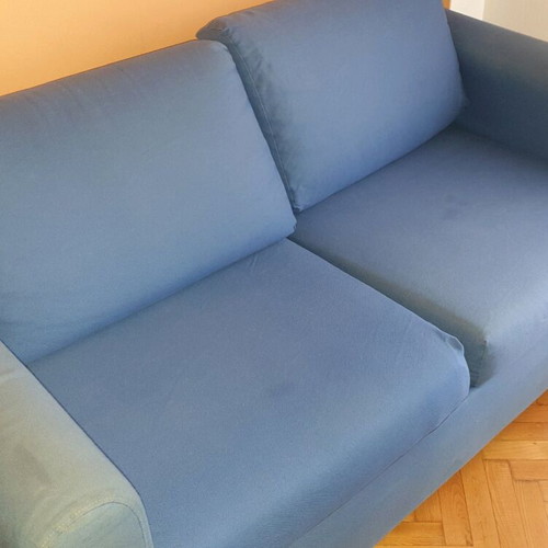 Two-seater sofa used without two back cushions