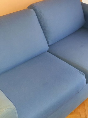 Two-seater sofa used without two back cushions