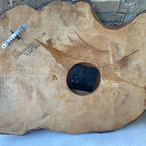 Handmade wooden wall clock from tree trunk.