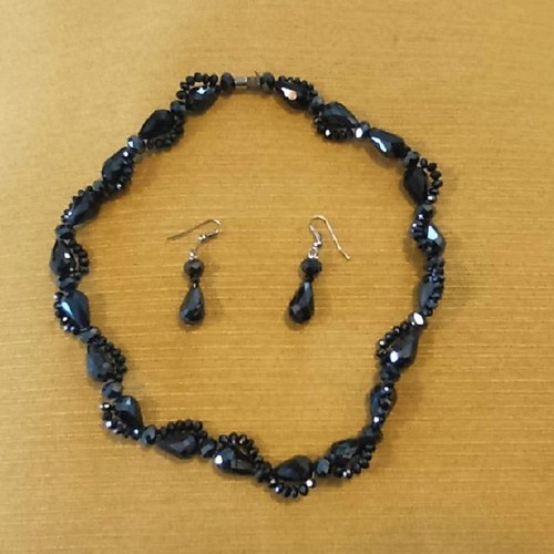 Jewelry set used with dark-colored stone necklace and earrings