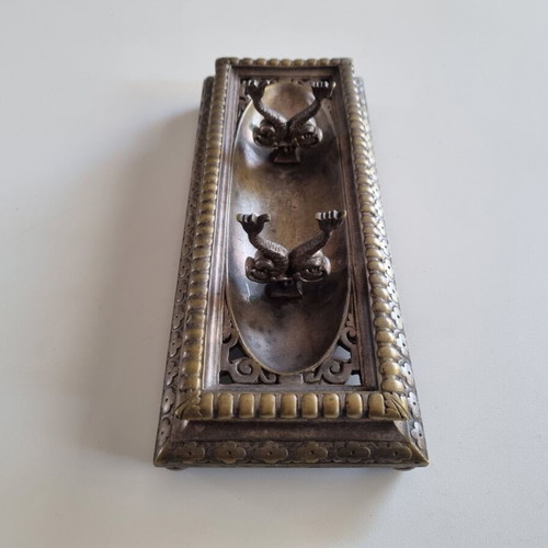 Vintage metal pen tray used with embossed floral motifs and dolphin supports