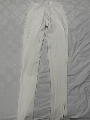 White elastic slim fit pants with ankle zippers
