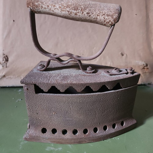 Charcoal iron used, traditional cast iron with wooden handle