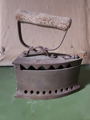 Charcoal iron used, traditional cast iron with wooden handle