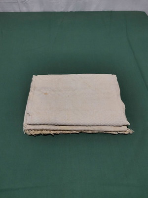 Woven piqué blanket used with wear from 1930 era