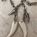 Necklace with plastic and metal fangs