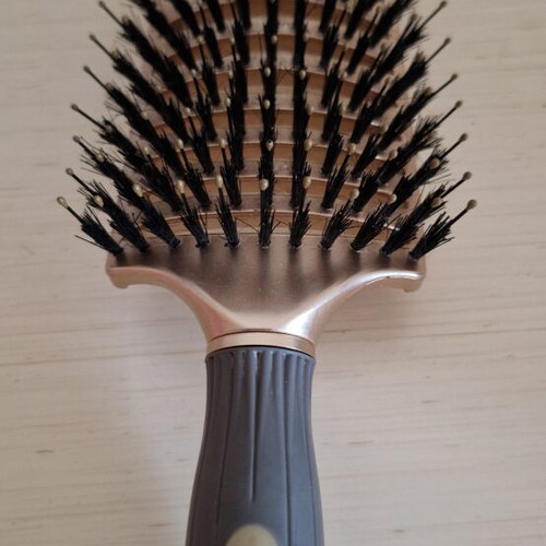 Hair comb with short bristles and openings